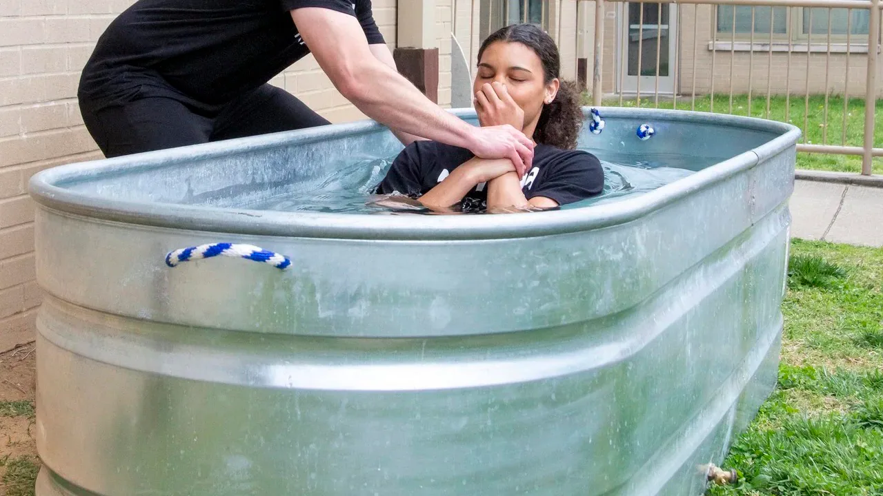 A young woman being baptized at Rhythm Church