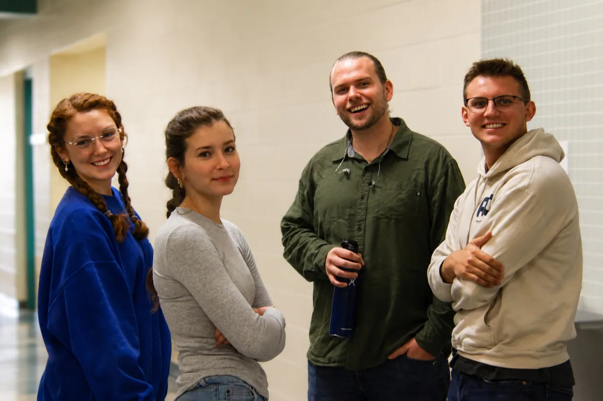 Four friends smiling together at Rhythm Church
